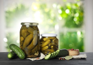 Image of Jars with pickled cucumbers on table indoors, space for text