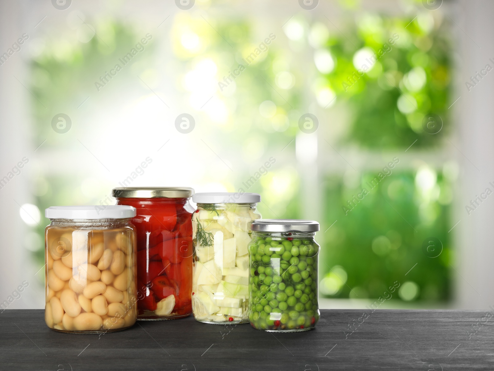 Image of Jars with pickled vegetables on table indoors, space for text