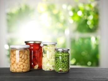 Image of Jars with pickled vegetables on table indoors, space for text