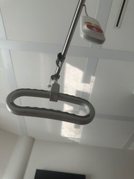 Photo of Element of hospital bed with remote controller in ward, low angle view