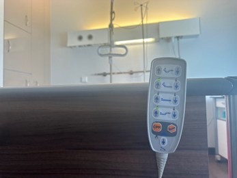 Photo of Bed`s remote controller in hospital ward, space for text