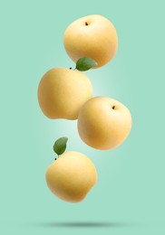 Image of Fresh apple pears falling on turquoise background