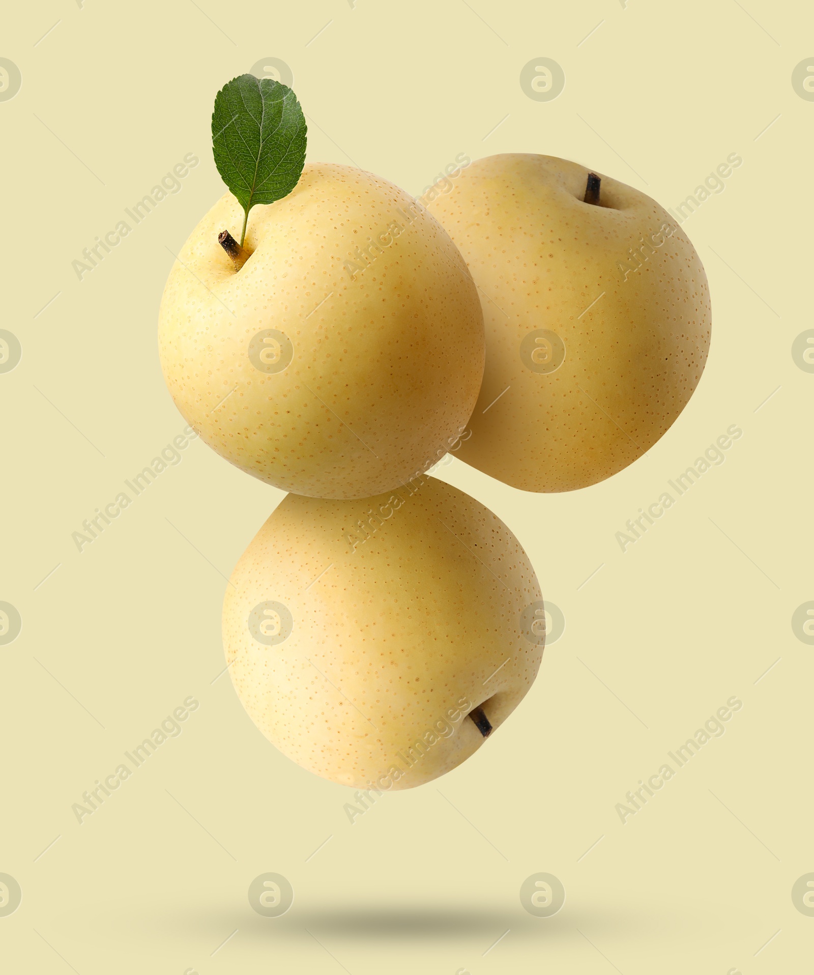 Image of Fresh apple pears falling on beige background