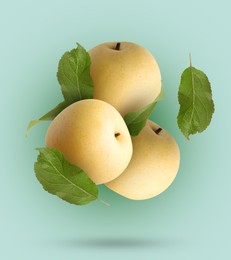 Image of Fresh apple pears and green leaves falling on turquoise gradient background