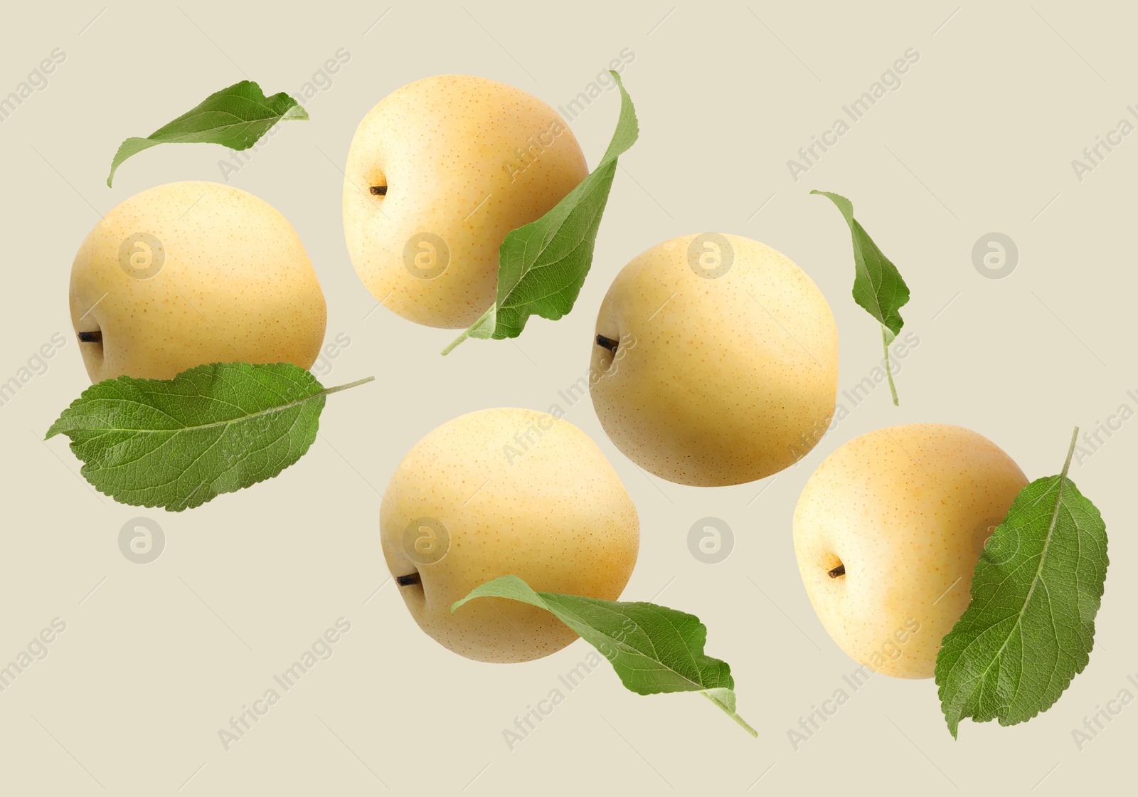 Image of Fresh apple pears and green leaves flying on dark beige background