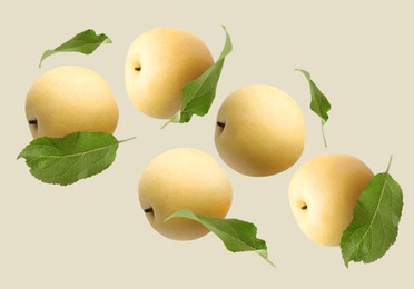 Image of Fresh apple pears and green leaves flying on dark beige background