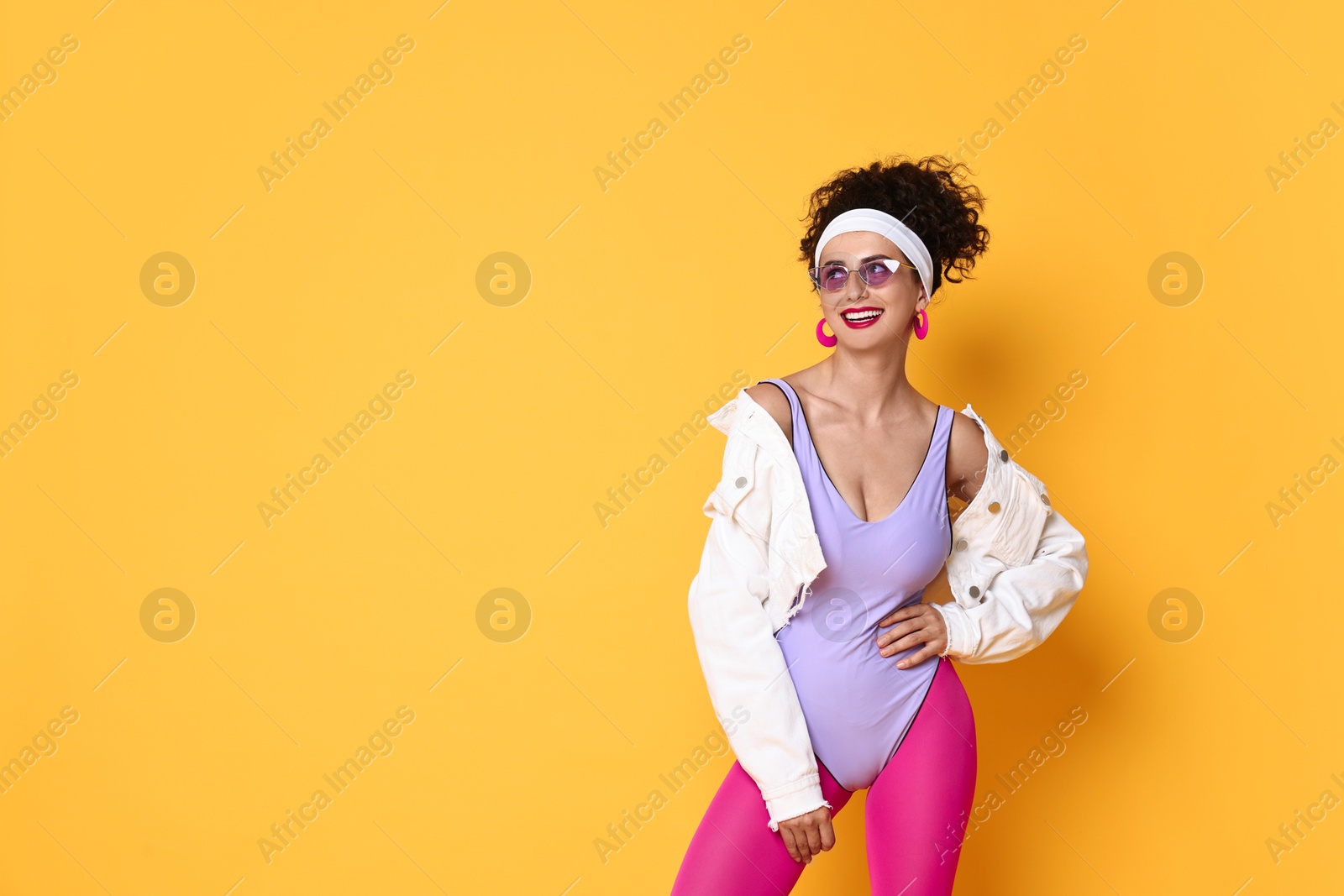 Photo of Aerobics. Happy woman in sportswear on orange background, space for text