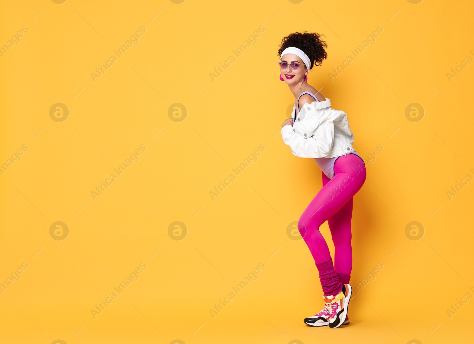 Photo of Aerobics. Happy woman in sportswear on orange background, space for text