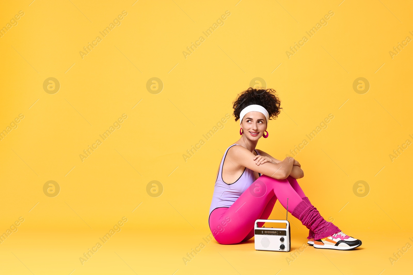 Photo of Aerobics. Woman with radio receiver on orange background, space for text