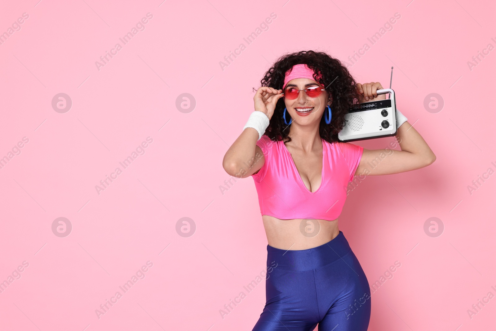 Photo of Aerobics. Woman with radio receiver on pink background, space for text