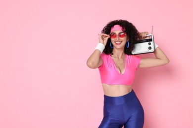 Photo of Aerobics. Woman with radio receiver on pink background, space for text