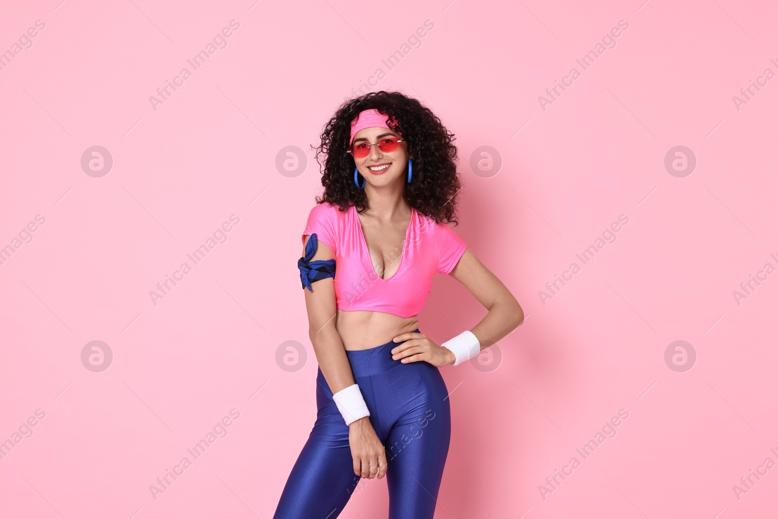 Photo of Aerobics. Happy woman in sportswear on pink background