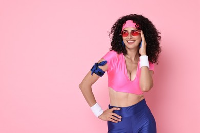 Aerobics. Happy woman in sportswear on pink background, space for text