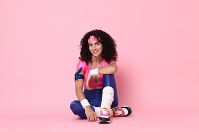 Aerobics. Happy woman in sportswear on pink background