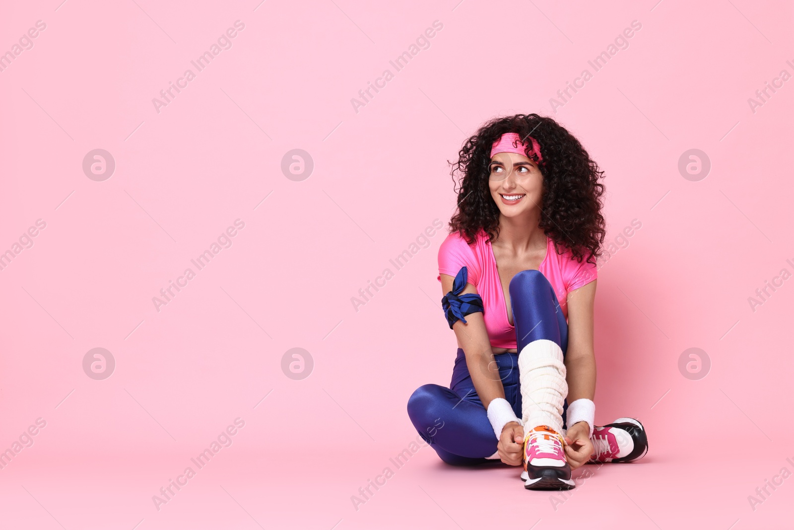 Photo of Aerobics. Happy woman in sportswear on pink background, space for text