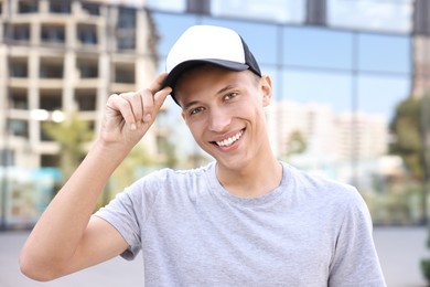 Portrait of smiling man in baseball cap outdoors