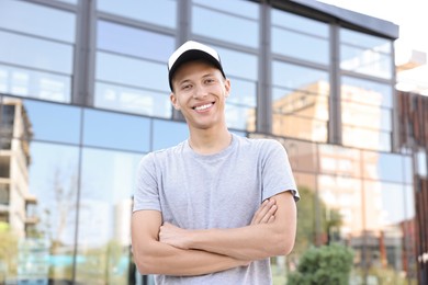 Photo of Portrait of smiling man in baseball cap outdoors