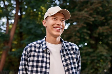 Portrait of smiling man in baseball cap outdoors