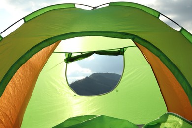 Photo of Tent on green grass against blue sky, low angle view