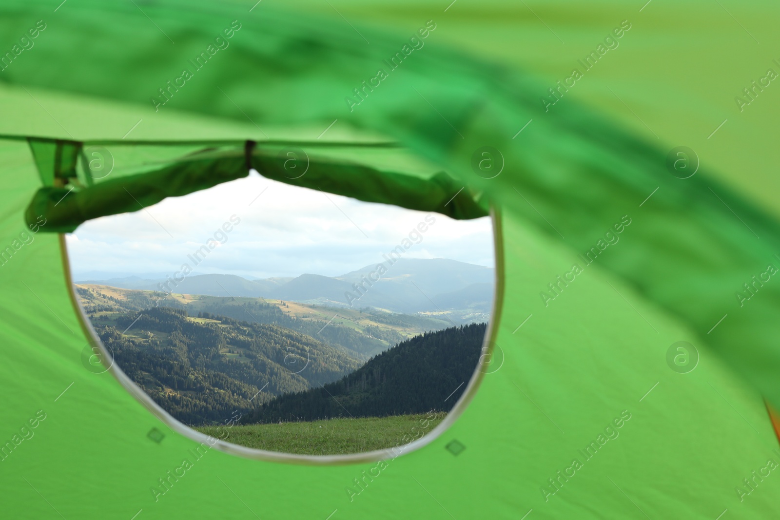 Photo of Picturesque view of mountains from green tent