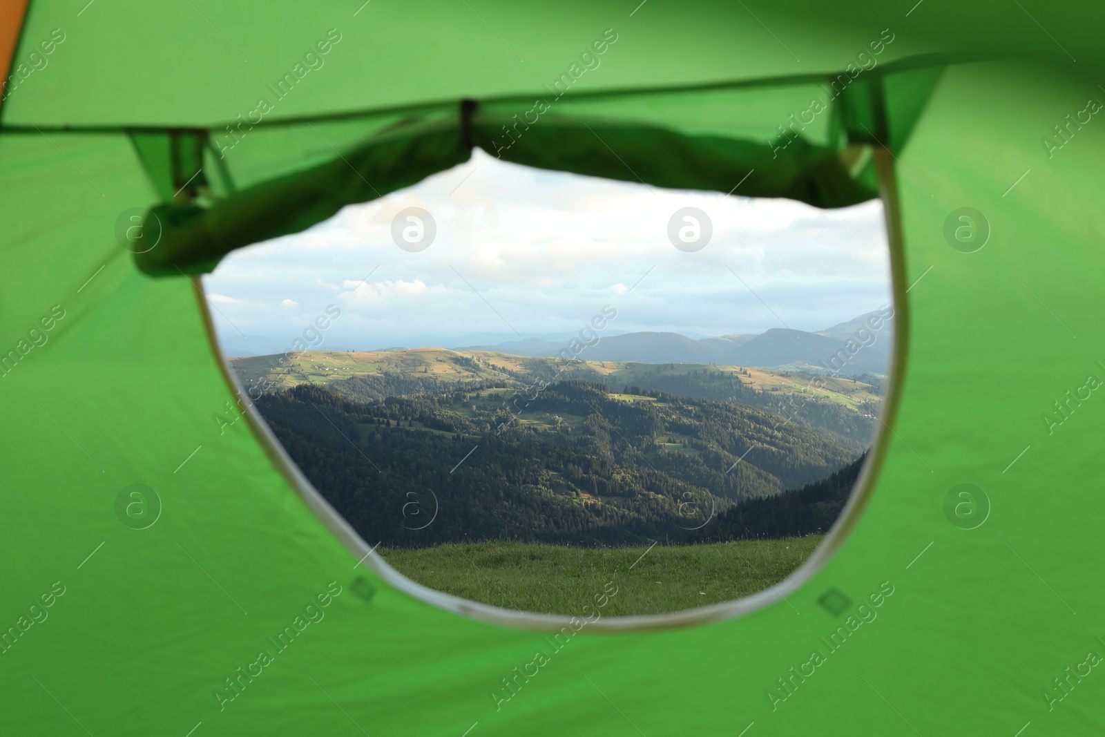 Photo of Picturesque view of mountains from green tent