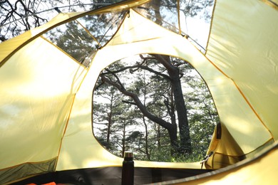 Photo of Modern camping tent in forest at summer, low angle view