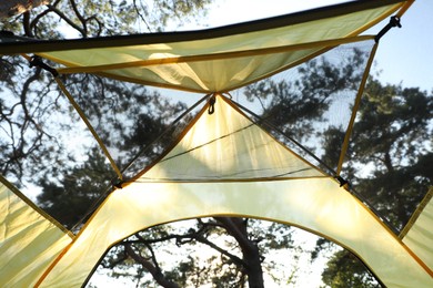 Photo of Modern camping tent in forest at summer, low angle view