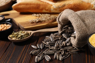 Photo of Different types of cereals, seeds and legumes on wooden table, closeup