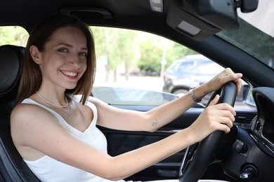 Photo of Woman holding steering wheel while driving car