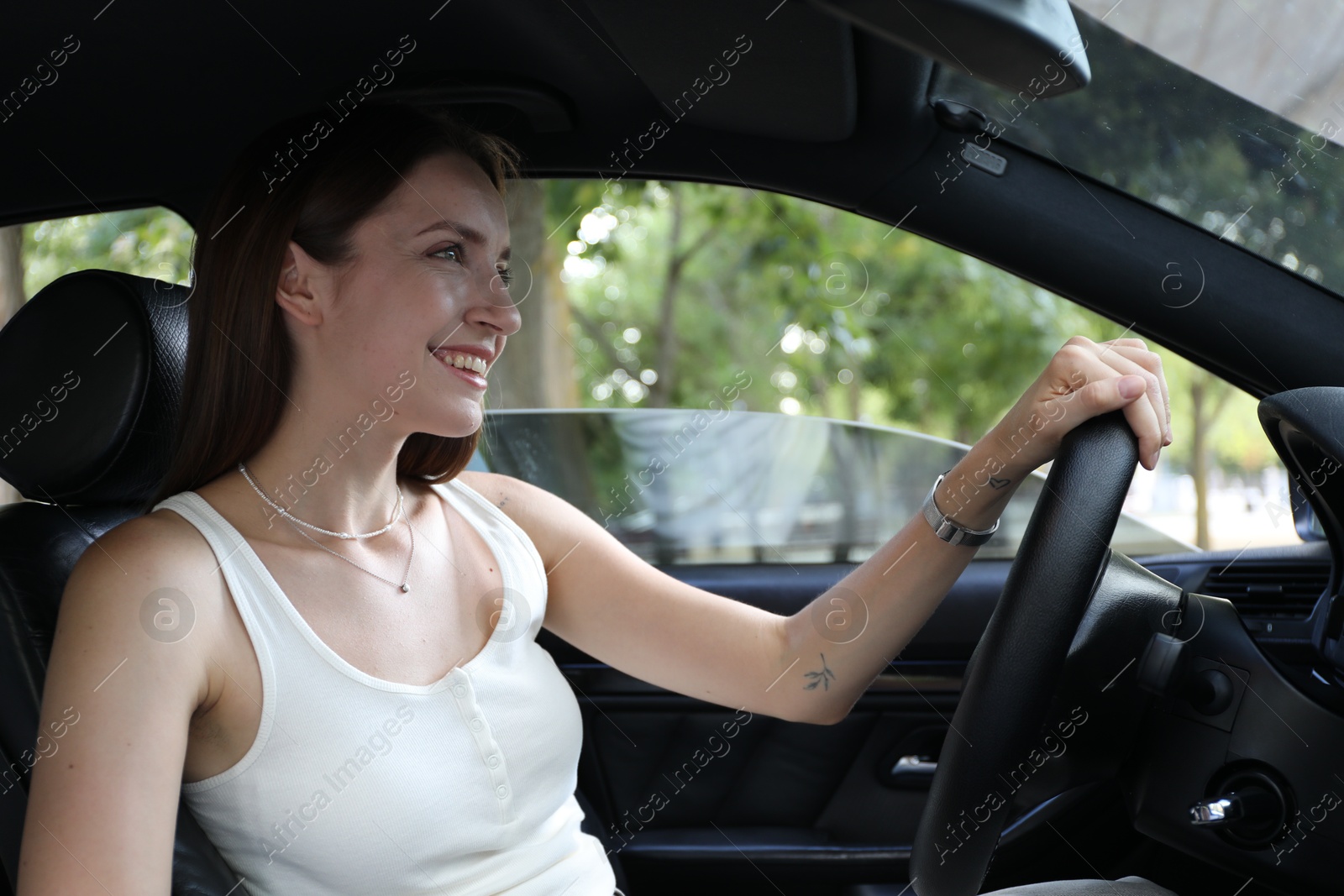 Photo of Woman holding steering wheel while driving car