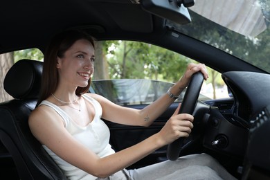 Woman holding steering wheel while driving car