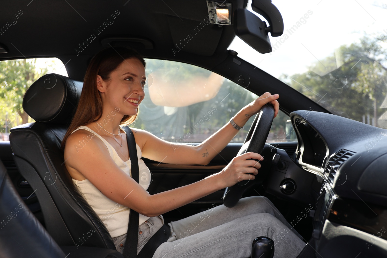 Photo of Woman holding steering wheel while driving car