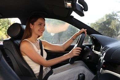 Woman holding steering wheel while driving car