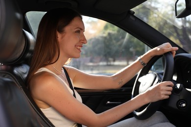 Woman holding steering wheel while driving car