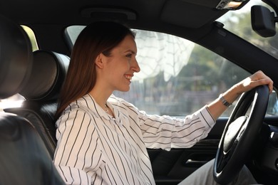 Photo of Woman holding steering wheel while driving car