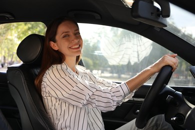 Photo of Woman holding steering wheel while driving car