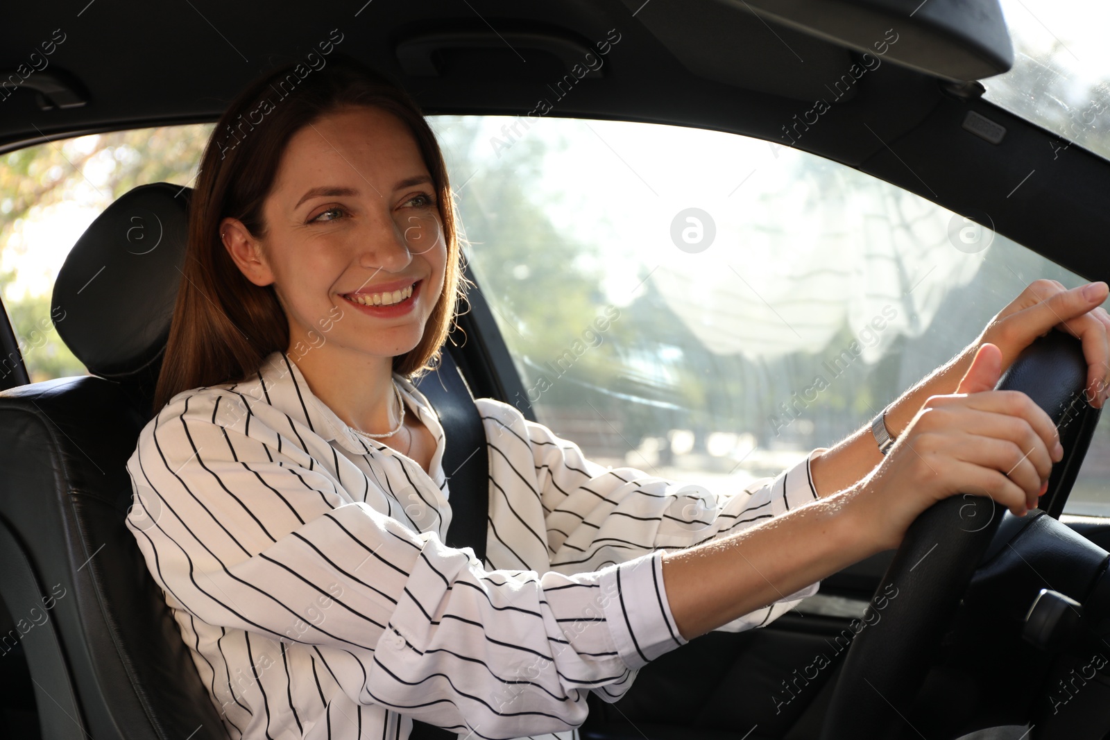 Photo of Woman holding steering wheel while driving car