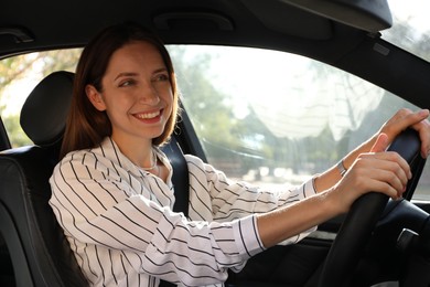 Woman holding steering wheel while driving car