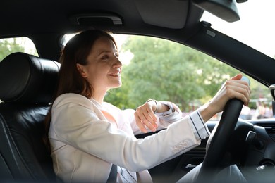 Woman holding steering wheel while driving car