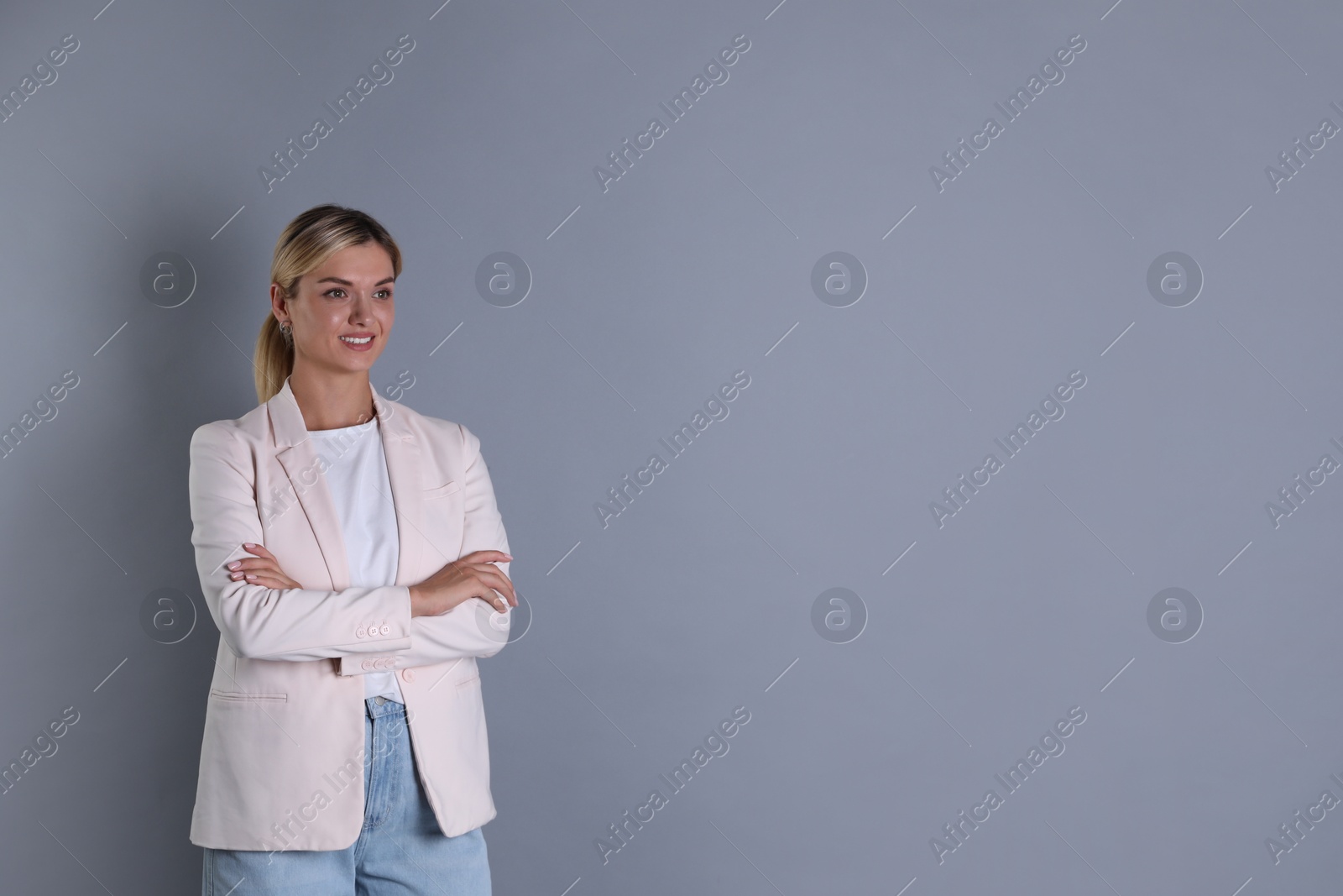 Photo of Beautiful woman in stylish jacket on grey background, space for text