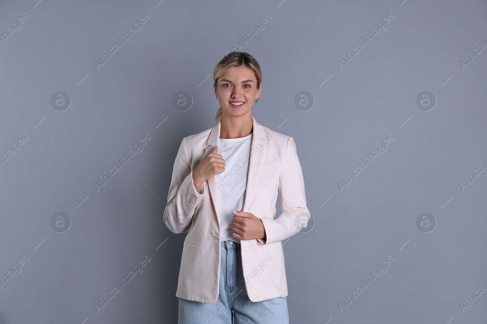 Photo of Beautiful woman in stylish jacket on grey background