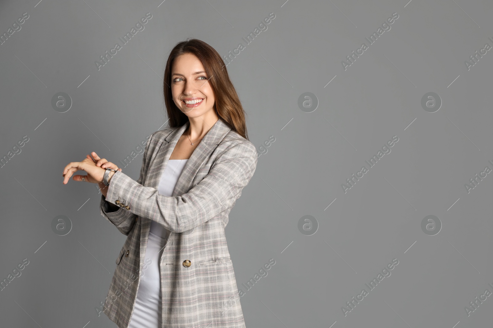 Photo of Beautiful woman in stylish jacket on grey background. Space for text