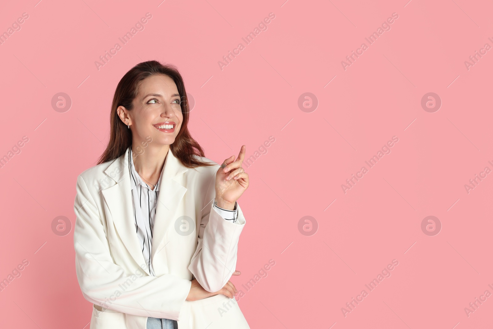 Photo of Beautiful woman in stylish white jacket on pink background, space for text