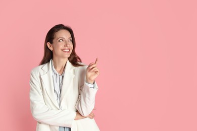 Photo of Beautiful woman in stylish white jacket on pink background, space for text