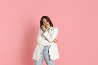 Photo of Beautiful woman in stylish white jacket on pink background