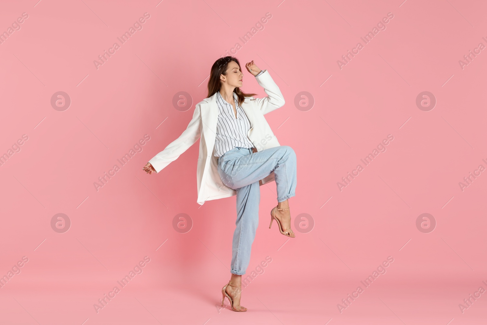 Photo of Beautiful woman in stylish white jacket on pink background