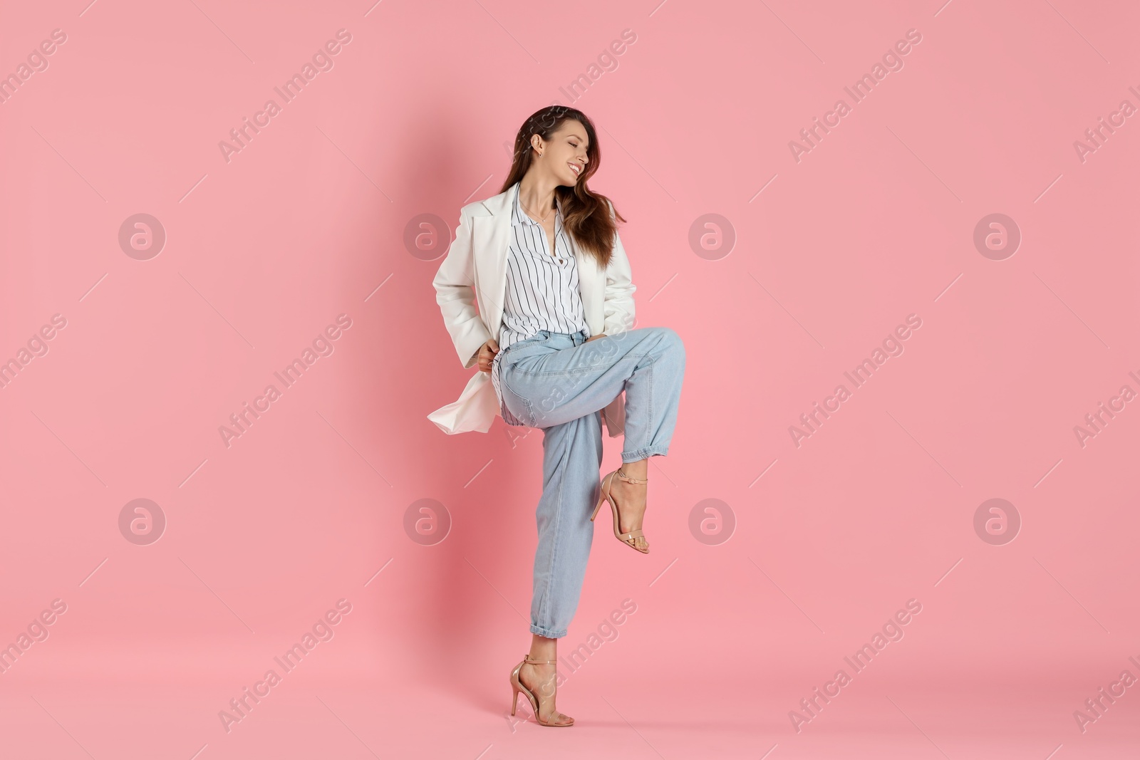 Photo of Beautiful woman in stylish white jacket on pink background