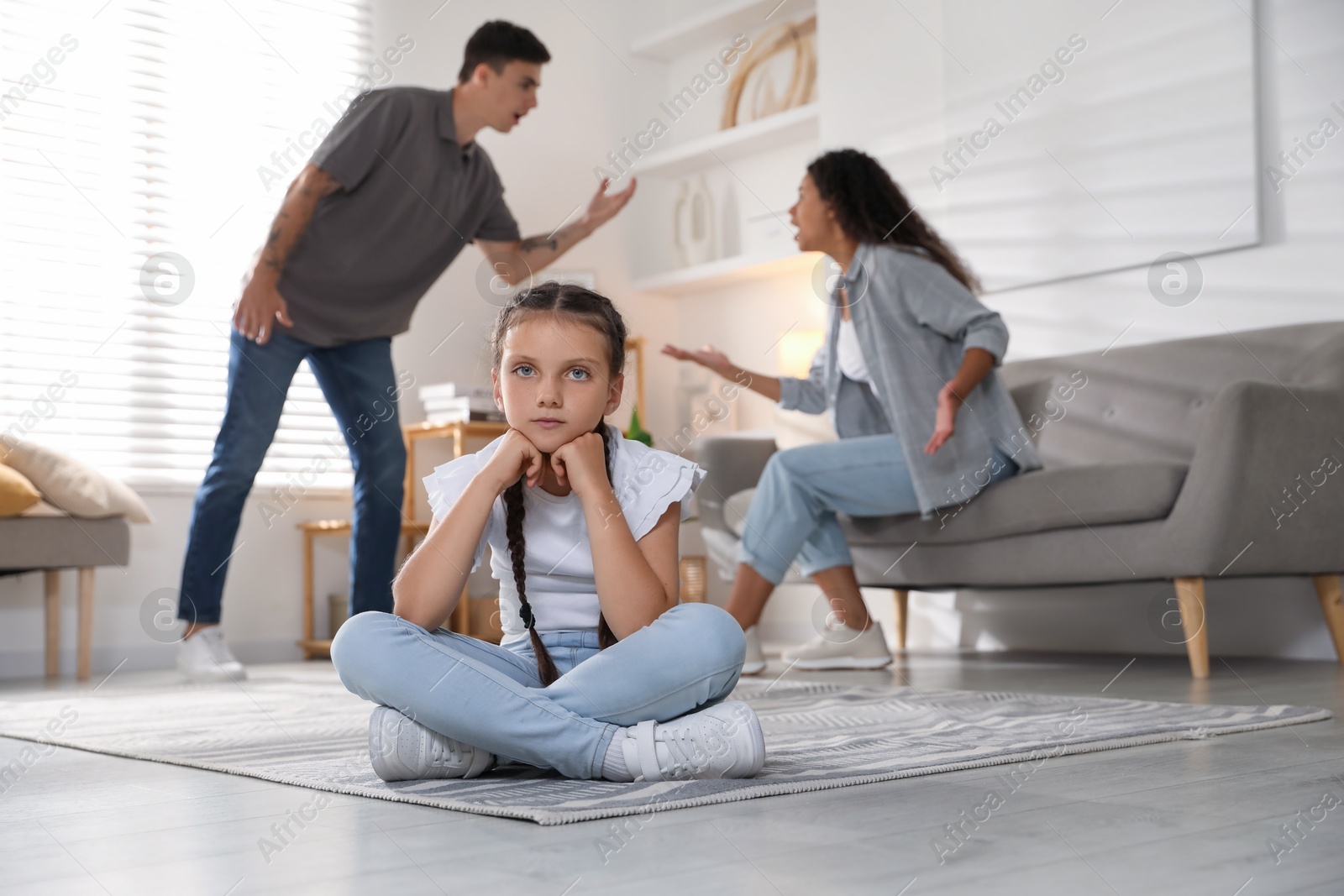 Photo of Divorce concept. Angry couple arguing at home, focus on their sad daughter