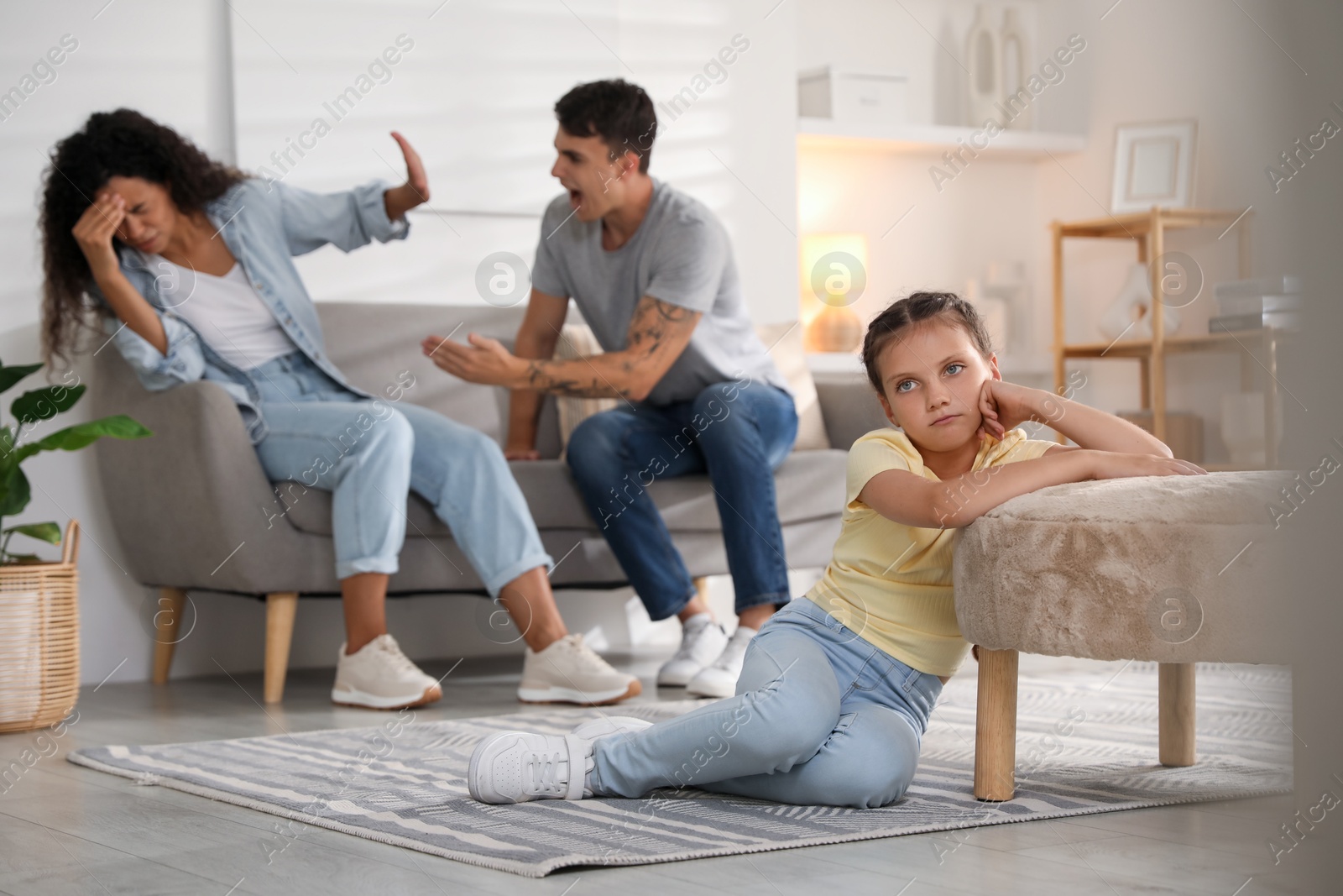 Photo of Divorce concept. Angry couple arguing at home, focus on their sad daughter