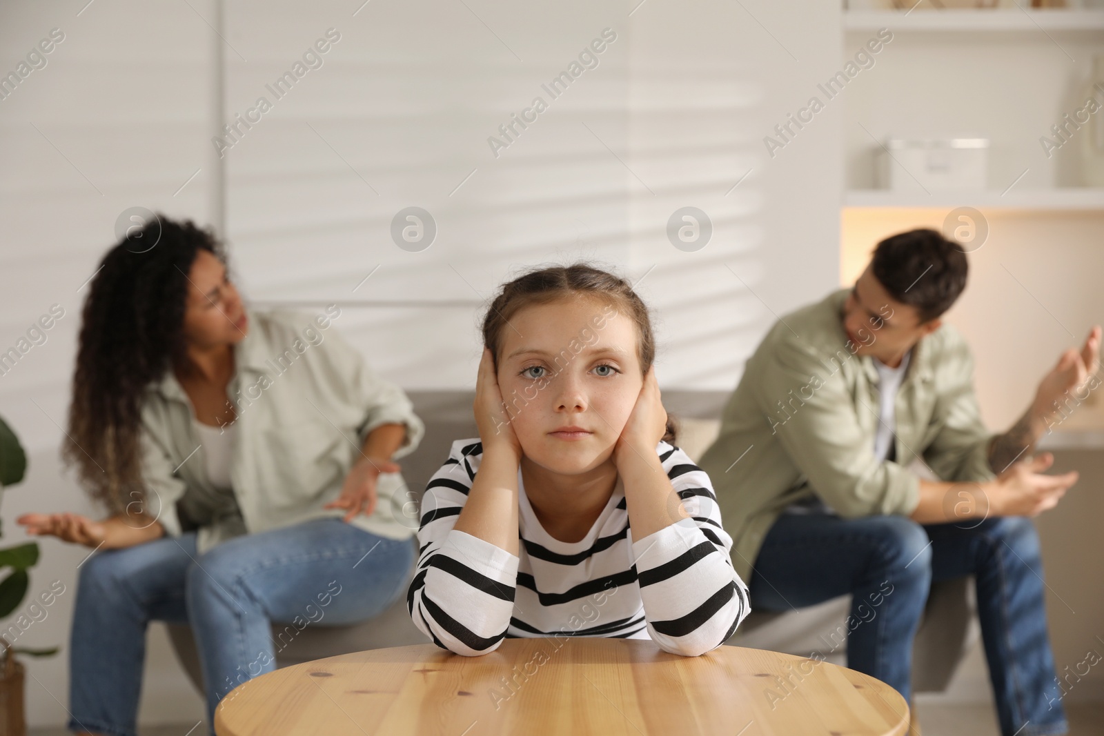 Photo of Divorce concept. Angry couple arguing at home, focus on their sad daughter